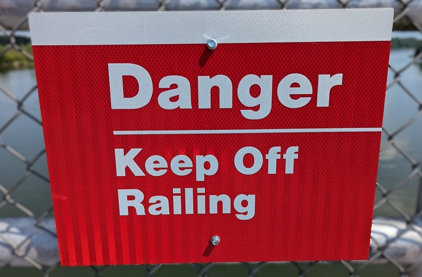 Red sign "Danger keep off Railing"